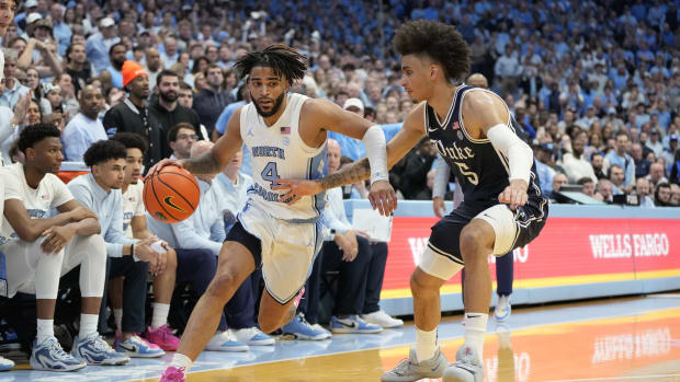North Carolina Tar Heels guard RJ Davis (4) dribbles as Duke Blue Devils guard Tyrese Proctor (5) defends in the second half at Dean E. Smith Center. 